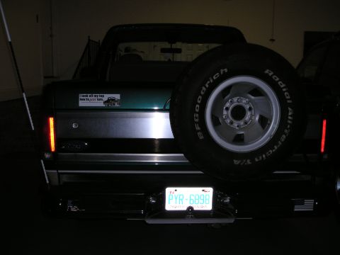 1996 Ford Bronco - Rear view of a green 1996 Ford Bronco, a spare tire and a "I took off my top now its just hers" sticker.