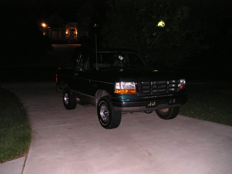 1996 Ford Bronco - This 1995 Ford F-150 pickup truck is parked in a driveway at night.