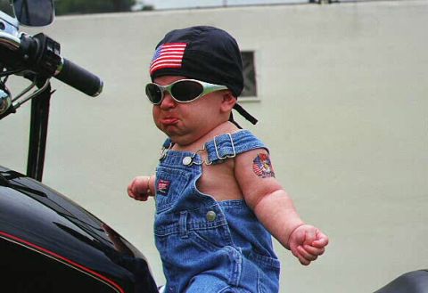 1997 Ford Expedition - A baby dressed as a biker sits on a motorcycle, looking grumpy.