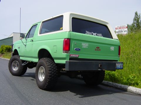 1990 Ford Bronco - Lifted 1990 Ford Bronco with a white removable top and custom rear bumper.