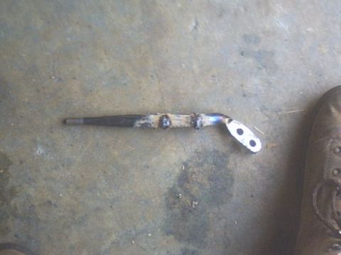 1991 Ford Crown Victoria - A metal bracket, likely a custom or replacement part, is shown on a concrete surface.
