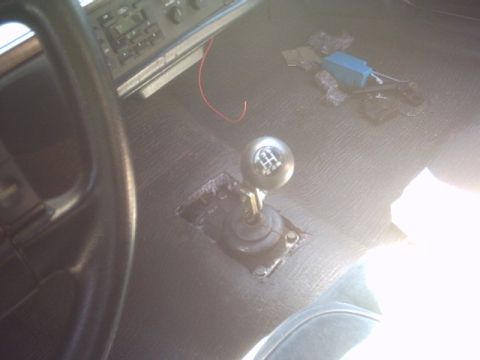 1991 Ford Crown Victoria - The interior of a vehicle is shown, focusing on the floor shifter and dashboard area.