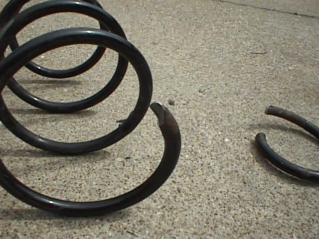 Broken coil spring on concrete surface