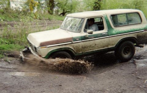 1978 Ford Bronco - This 1978 Ford Bronco navigates a muddy track, kicking up a spray of water.