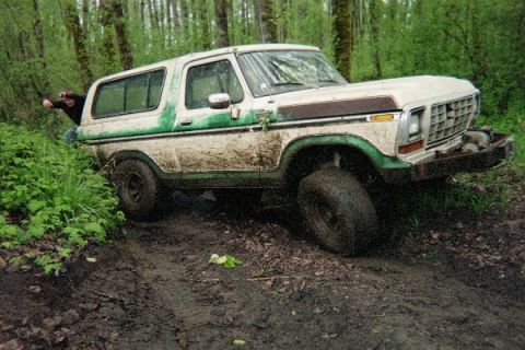 1978 Ford Bronco - This 1978 Ford Bronco is deep in the mud, off-roading in a wooded area.