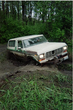 1978 Ford Bronco - This 1978 Ford Bronco is deep in the mud, navigating a wooded off-road trail.