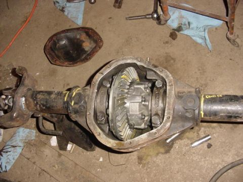 1992 Ford Bronco - Differential housing with internal gears visible, differential cover removed and placed nearby.