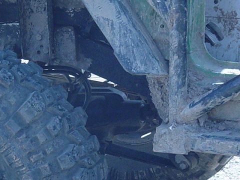 1992 Ford Bronco - Close-up of the undercarriage and suspension components of a modified off-road vehicle.