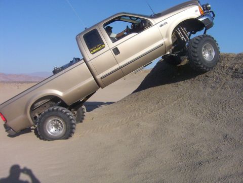 2000 Ford F-450 - This lifted Ford F-450 is shown navigating a steep dirt incline.