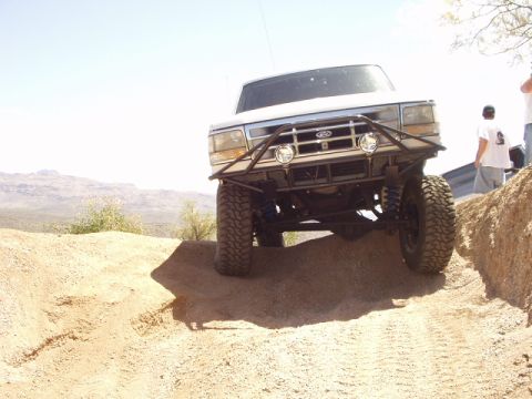 1993 Ford Bronco - This 1993 Ford Bronco is tackling an off-road trail with its modified suspension and bumper.