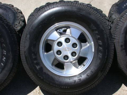 1996 Ford Bronco - Set of four tires and wheels, one a Chevrolet emblem on the center cap.