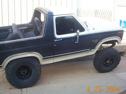 1986 Ford Bronco - This lifted Ford Bronco features a two-tone paint scheme and aggressive off-road tires.