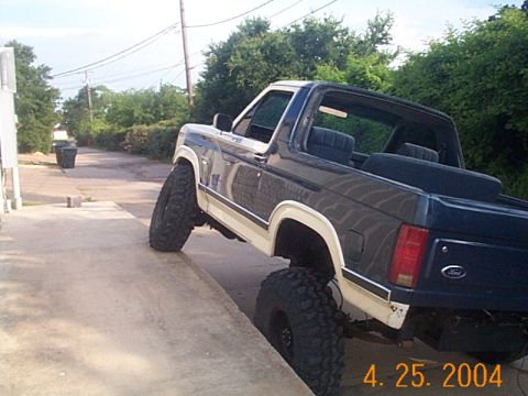 1986 Ford Bronco - This 1986 Ford Bronco features a two-tone paint scheme and an elevated suspension system.