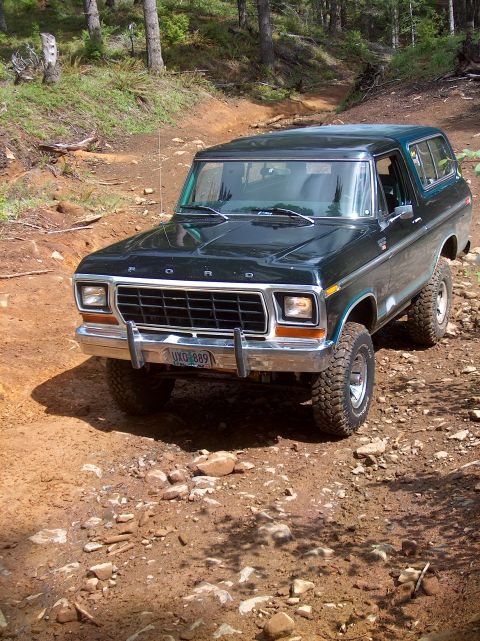 1978 Ford Bronco - This Ford Bronco is driving on a rocky, dirt path through a wooded area.