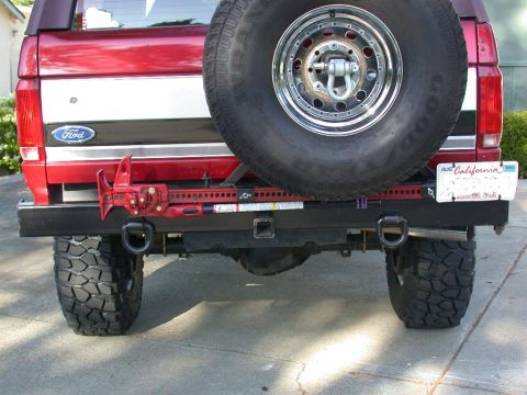 1996 Ford Bronco - This Ford Bronco features a heavy-duty rear bumper with a mounted spare tire and a Hi-Lift jack for off-road recovery.