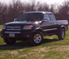 1988 Ford Bronco - A black Toyota Tundra pickup truck is shown from the front three-quarter angle, parked outdoors.