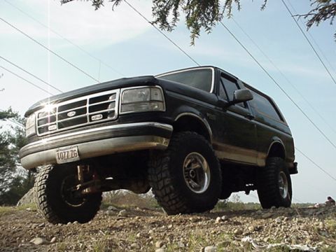 1993 Ford Bronco - This 1993 Ford Bronco is shown from a low angle, highlighting its lifted suspension and off-road tires.