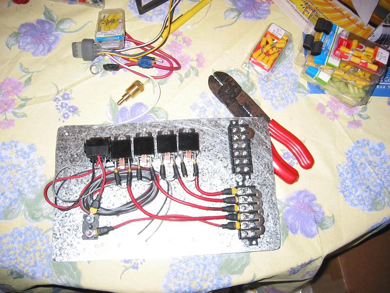 Homemade aluminum relay board with five relays and terminal strips, wired with red leads