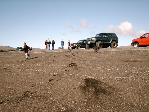 1996 Ford Bronco - Several off-road vehicles are parked on a sandy landscape under a clear blue sky.