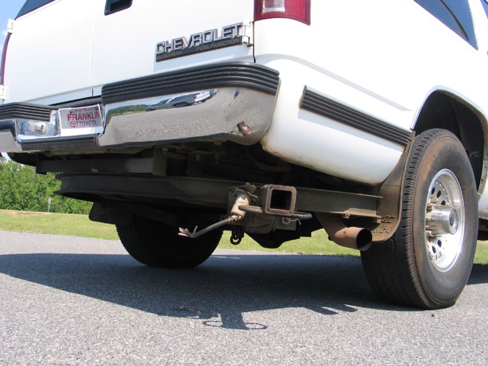 Rear view of a white Chevrolet pickup truck with a trailer hitch and a license plate frame from Franklin Toyota