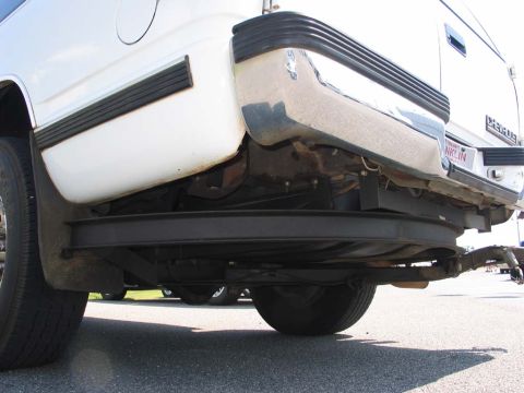 1995 Ford Bronco - The rear of a white vehicle is shown, focusing on the bumper and undercarriage details.