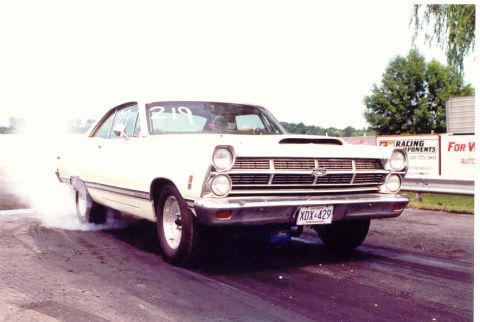 1967 Ford Fairlane - White 1967 Ford Fairlane performing a burnout at a drag race event.