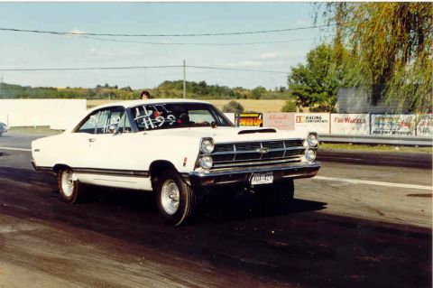1967 Ford Fairlane - White 1967 Ford Fairlane drag car with hood scoop and racing slicks on the track.