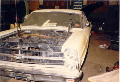 1967 Ford Fairlane - Front view of a 1967 Ford Fairlane with its hood open, showing the engine bay. Another vehicle is visible in the background.
