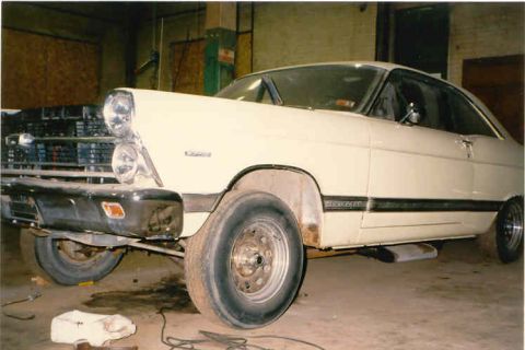 1967 Ford Fairlane - A white 1966 Ford Fairlane is parked in a garage, showing its front end and side profile.