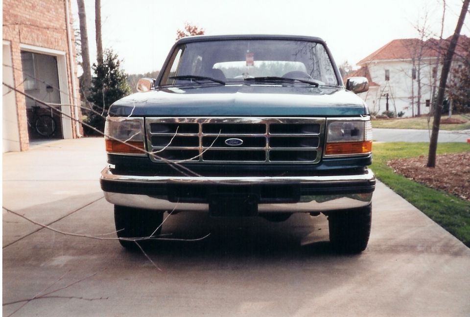 Front view of a green Ford F-Series truck. Grille has horizontal bars and a Ford emblem