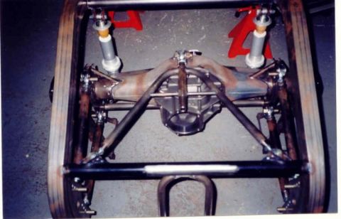 1967 Ford Fairlane - Custom rear axle assembly with shocks and suspension links, mounted on jack stands.