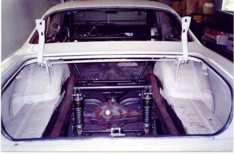 1967 Ford Fairlane - Rear view of a 1967 Ford Fairlane with its trunk open, revealing a modified suspension system.