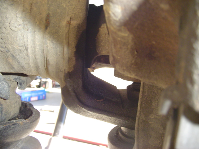 Close-up of rusty vehicle suspension parts, possibly a ball joint assembly