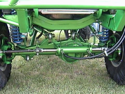1995 Ford Bronco - Close-up of a heavily modified front axle assembly with custom suspension components.