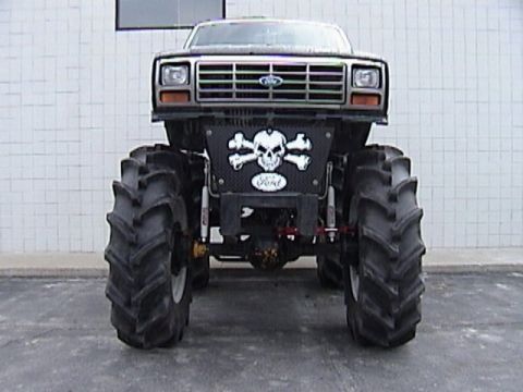 1995 Ford Bronco - This modified truck features oversized tires and a skull and crossbones graphic on the front.