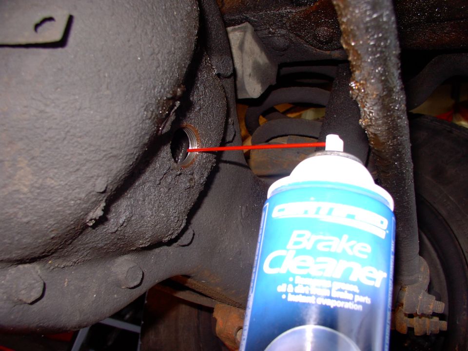 Hose the whole thing out with some brake cleaner.  I even put the new plug in and soaked it for a while before draining one last time.