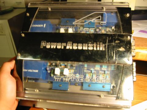 1985 Ford Bronco - A PowerAcoustik amplifier is shown, internal circuitry and warning labels.