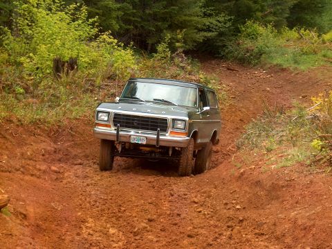 1978 Ford Bronco - 1978 Ford Bronco navigates a challenging muddy off-road path.