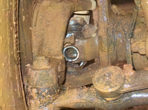 1978 Ford Bronco - Close-up of heavily soiled vehicle undercarriage components, obscuring specific model identification.