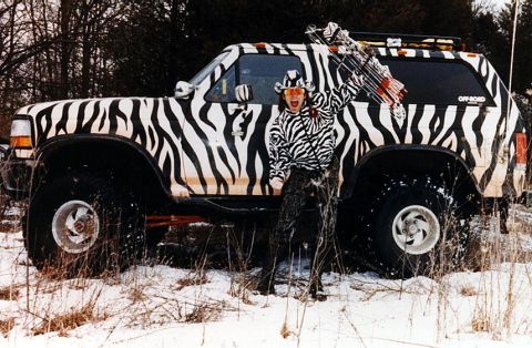 1986 Ford Bronco - This custom-painted SUV, likely a 1992 Ford Bronco, features a striking zebra print wrap and an "OFF-ROAD" decal.
