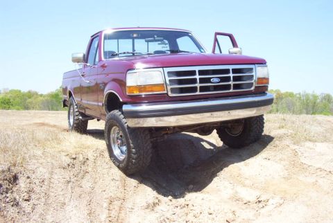 1992 Ford F-150 - This Ford F-150 pickup truck is shown from the front on a sunny day with a clear blue sky.