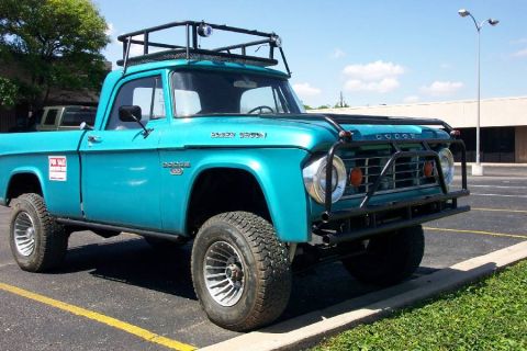 1992 Ford Bronco - This turquoise Dodge pickup truck features a roof rack and a heavy-duty bull bar, suggesting it's equipped for off-road adventures.