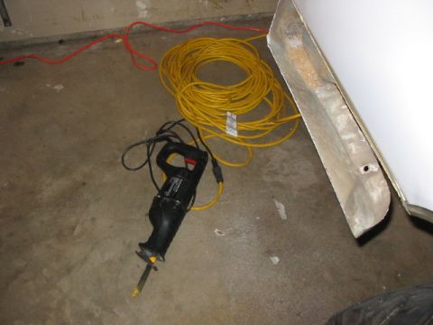 1995 Ford Bronco - Tools and cords are laid out on the floor, possibly for a repair or construction project.