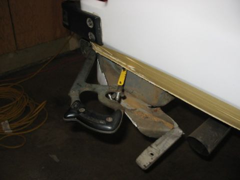 1995 Ford Bronco - Close-up of a damaged vehicle bumper and trim, with tools attached.