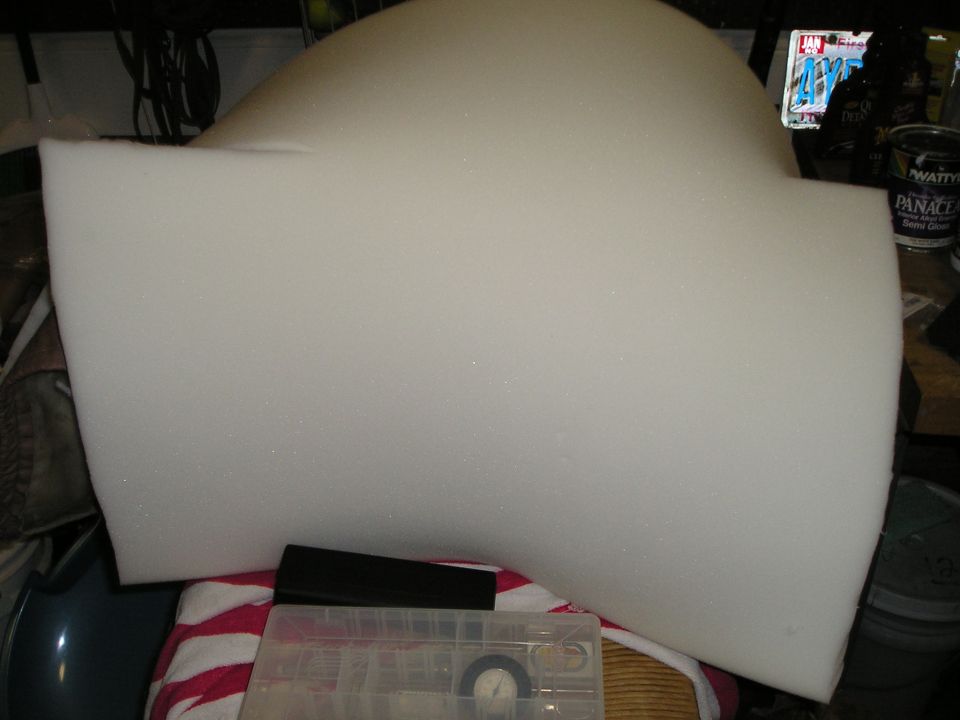 Sheet of white upholstery foam cut to shape on a garage workbench