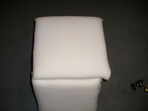 1996 Ford Bronco - Foam padding is shown against a dark background with some small electronic components to the right.