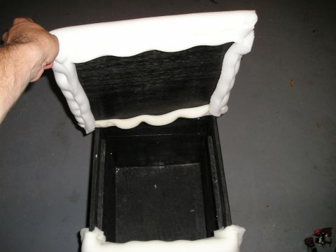 1996 Ford Bronco - A custom center console is being held up, revealing its interior and white foam padding.