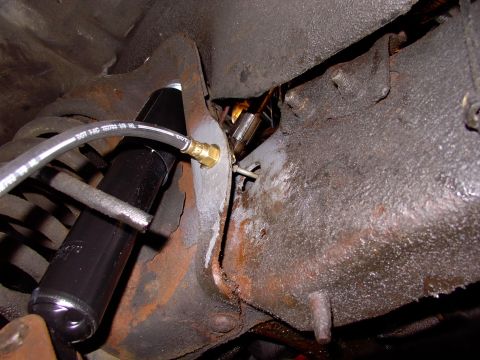 1986 Ford Bronco - There's the new line passing through the frame rail going into the new hose. 20 more years out of her !