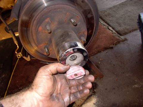 1986 Ford Bronco - First thing off, after the caliper. Ford wants $64 CDN for this red(now pink) faded plastic twist lock. Guess I'll be yarding again soon wi…