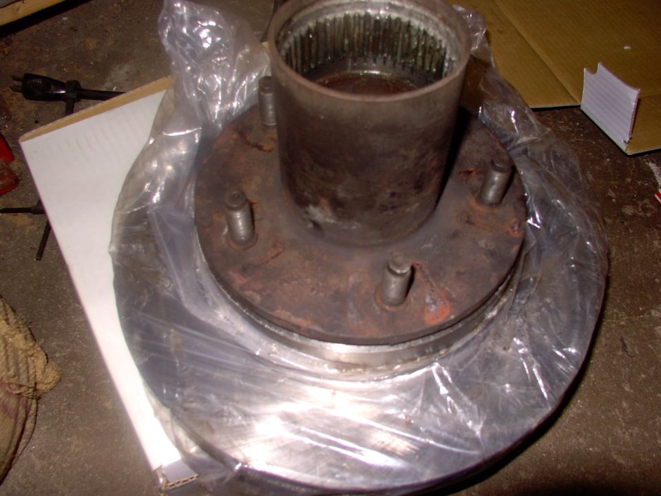 I just left the plastic rotor bag on until I get it mounted so I can grease the hub without doing the rotor too.